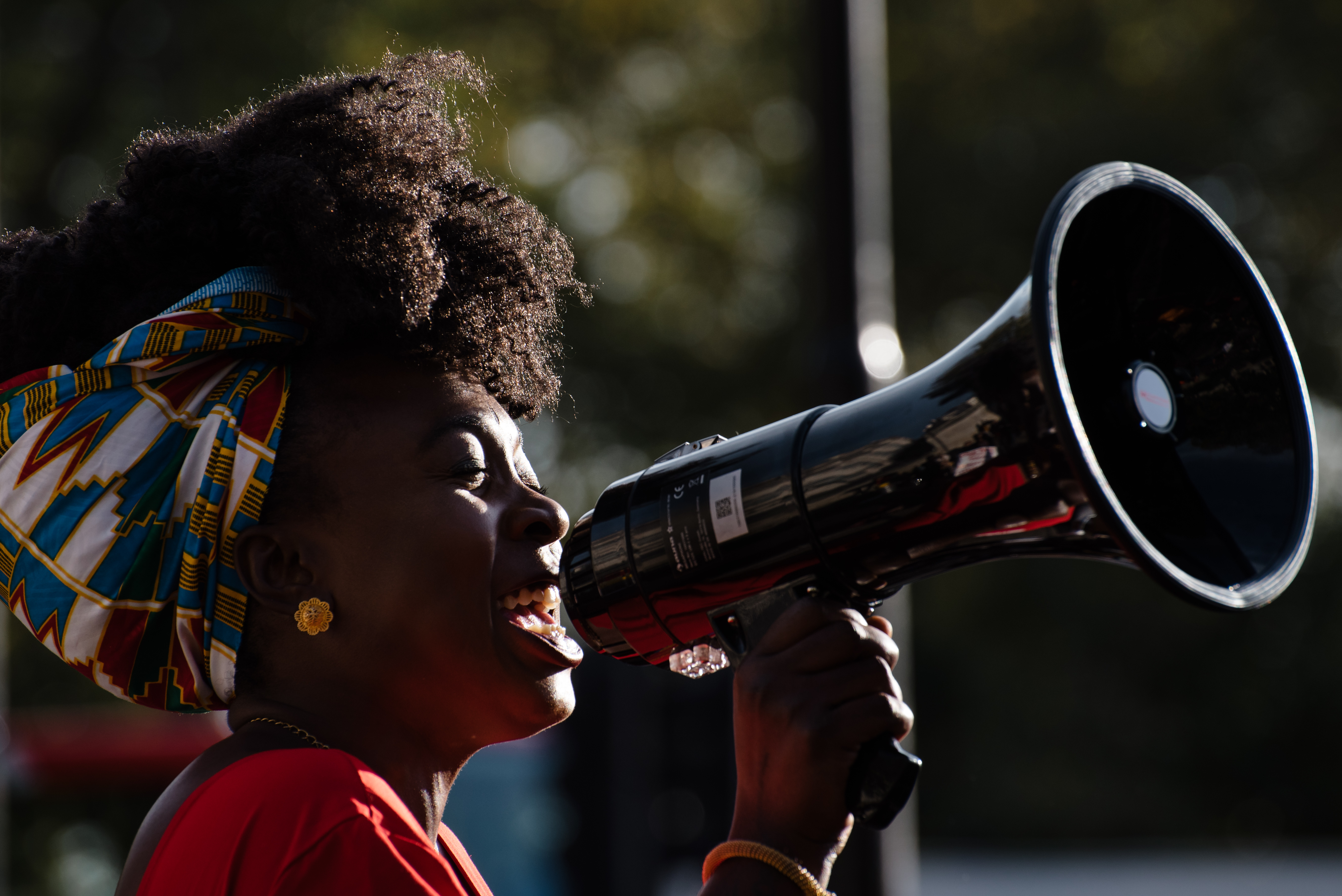 Young woman with bullhorn. Editorial credit: Andrea Domeniconi /Shutterstock.com